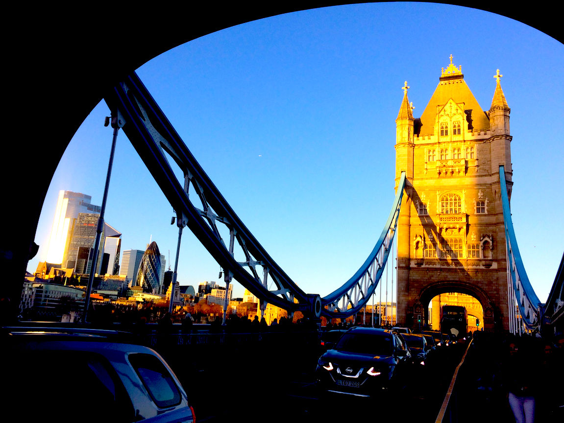 The image is a photo of Tower Bridge.   The "chains" follow a  catenary curve, similar to a parabola.